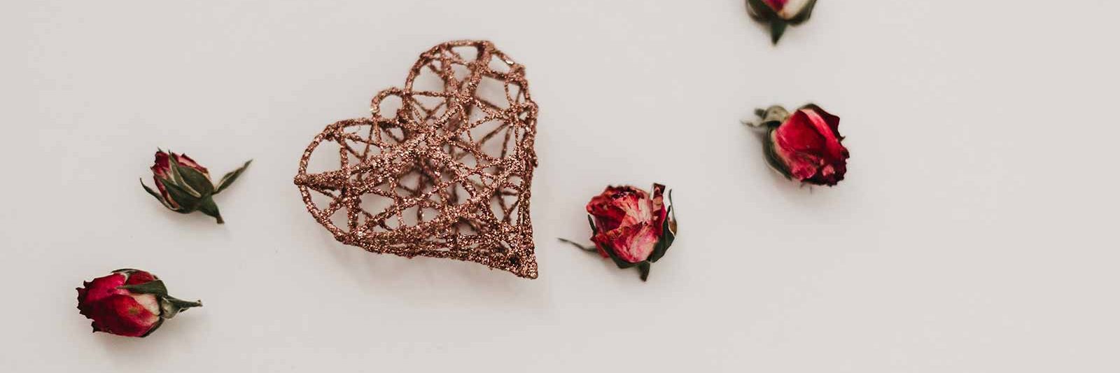 rosebuds and a wicker heart on a beige background